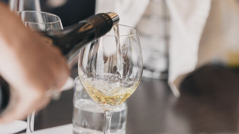 Pouring white wine White wine glass